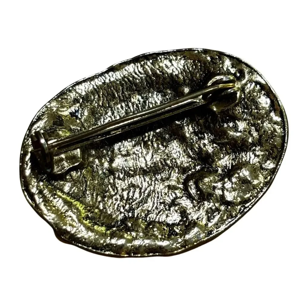 Vintage gold tone metal brooch relief repousse style oval dancing winged cupids